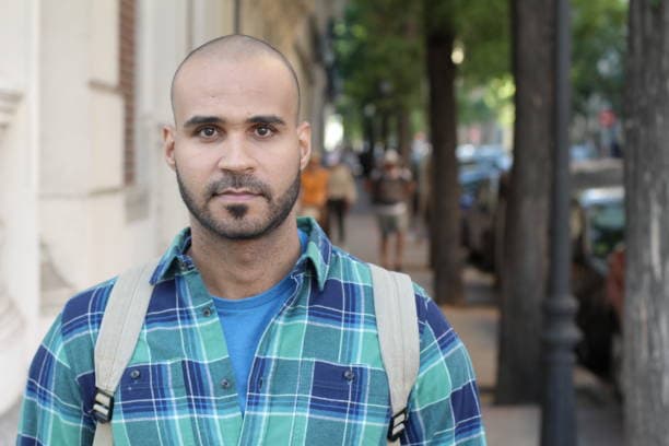 A man with glasses and a backpack